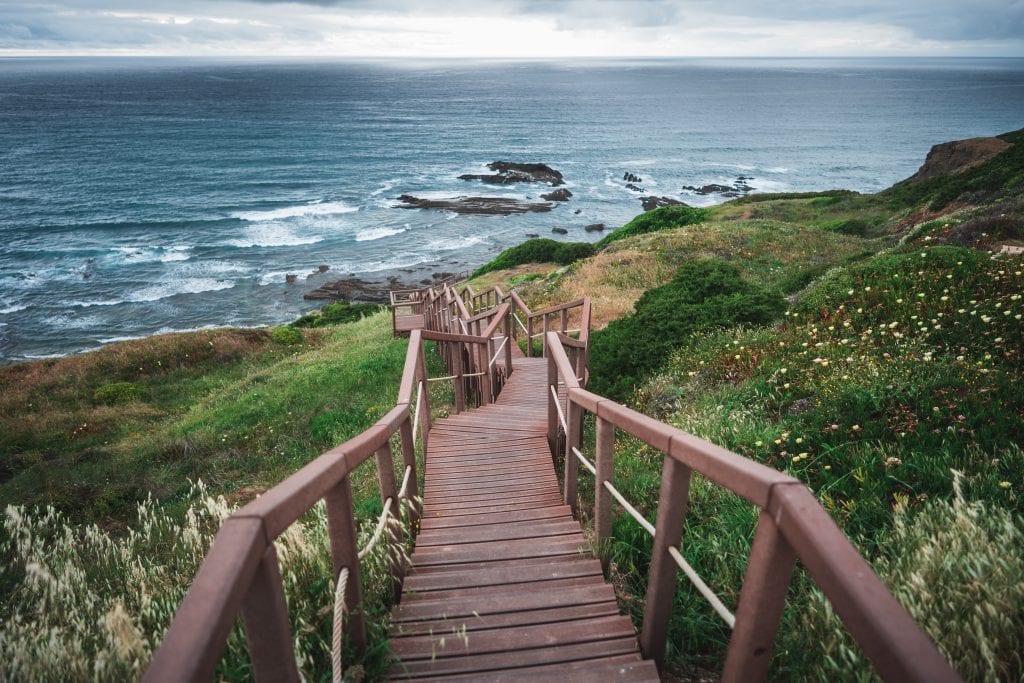 Picture of a long winding wooden stairway down a hill to a beach